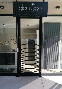 Steel security gate fitted at a shop entrance
